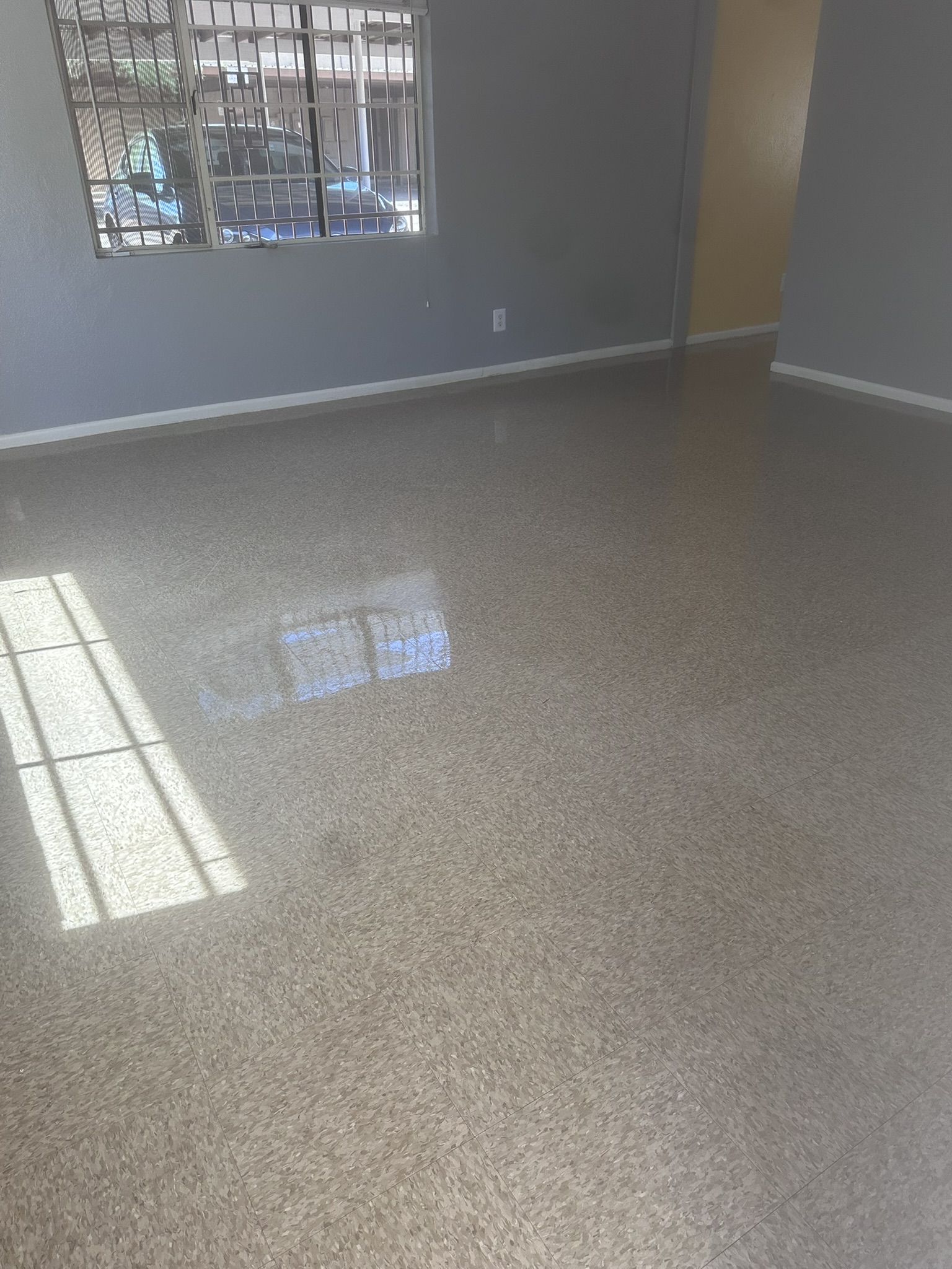 Living room VCT floor after strip and wax service